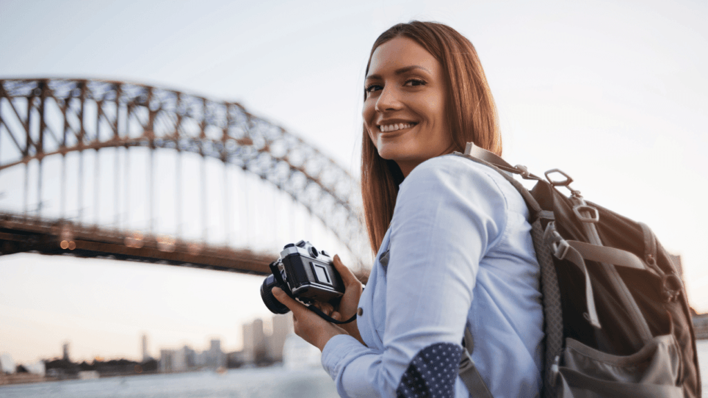 A woman in front of the Harbour Bridge in Sydney.